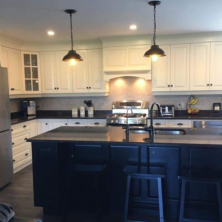 Wide view of kitchen with new pendant lighting and pot lights